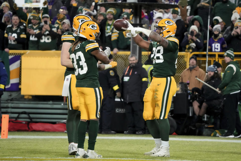 Green Bay Packers running back AJ Dillon (28) celebrates with teammates after scoring on a 2-yard touchdown run during the second half of an NFL football game against the Minnesota Vikings, Sunday, Jan. 1, 2023, in Green Bay, Wis. (AP Photo/Morry Gash)