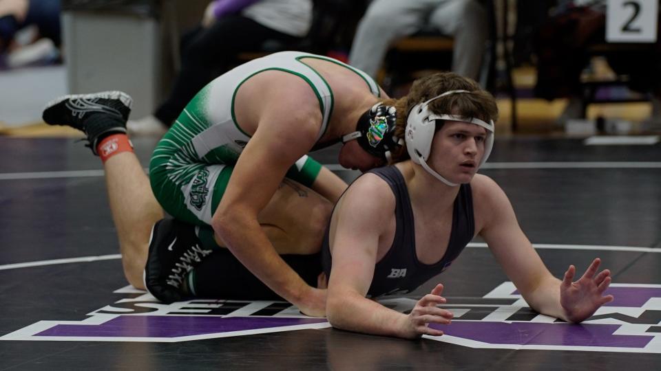 Mason's Kameron Dennis looks to the referee as Harrison's Dickie Engel holds him down in a matchup in the 175-pound bracket of the SWOWCA Coaches Classic at Middletown High School on Dec. 22, 2023.