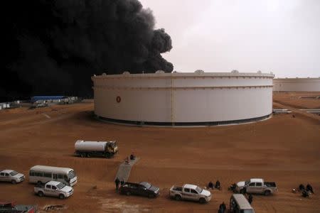 Smoke rises from burning oil storage tanks in the port of Ras Lanuf, Libya, January 23, 2016. REUTERS/Stringer