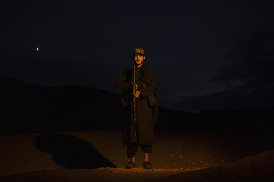 21 year-old Taliban fighter Ahmad Wali poses for a photo in Kamar Kalagh village, near Herat, Afghanistan, on Saturday, Nov. 27, 2021. Since the Taliban's takeover of Afghanistan just over three months ago amid a chaotic withdrawal of U.S. and NATO troops, its fighters have changed roles, turning from fighting in the mountains and the fields to running the country. (AP Photo/ Petros Giannakouris)