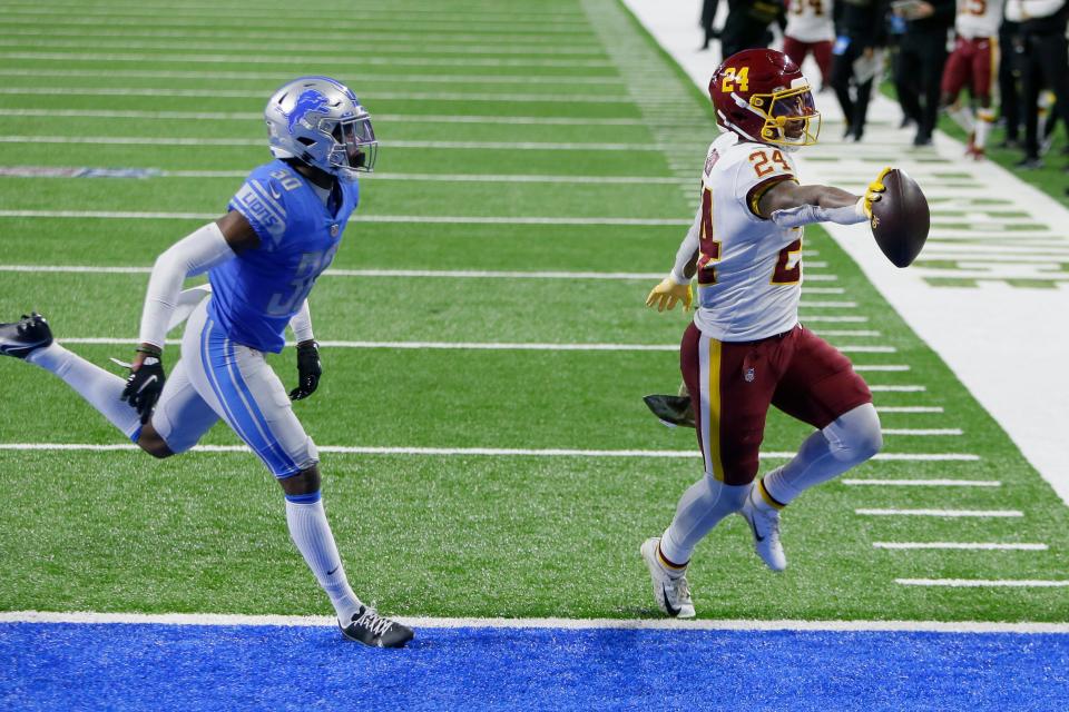 Washington Football Team running back Antonio Gibson (24), chased by Detroit Lions cornerback Jeff Okudah (30), carries the ball into the end zone for a touchdown during the second half of an NFL football game, Sunday, Nov. 15, 2020, in Detroit. (AP Photo/Duane Burleson)