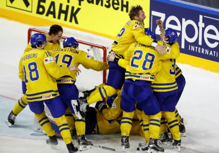 Sweden's players celebrate after winning the penalty shoot-out of the IIHF Men's World Championship Ice Hockey final match on May 21, 2017