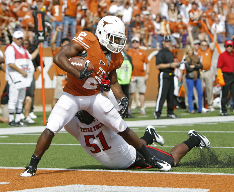 AUSTIN, TX - NOVEMBER 5: Running back Fozzy Whittaker #2 of the Texas Longhorns scores a second quarter touchdown against linebacker Cqulin (cq) Hubert #51 of the Texas Tech Red Raiders on November 5, 2011 at Darrell K. Royal-Texas Memorial Stadium in Austin, Texas. (Photo by Erich Schlegel/Getty Images)