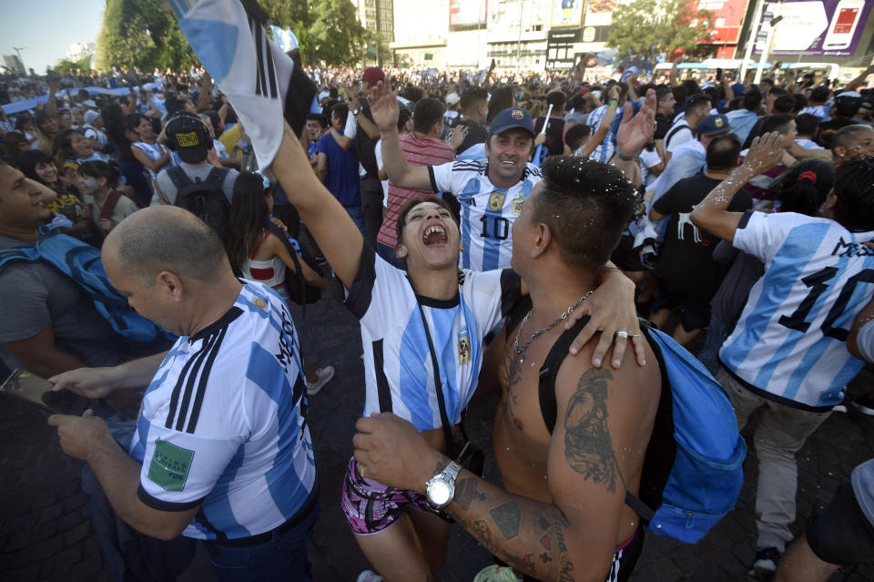 Argentina soccer fans celebrate their team's victory over Croatia at the end of the team's World Cup semifinal match in Qatar after watching it on a screen set up in the Palermo neighborhood of Buenos Aires, Argentina, Tuesday, Dec. 13, 2022. (AP Photo/Gustavo Garello)