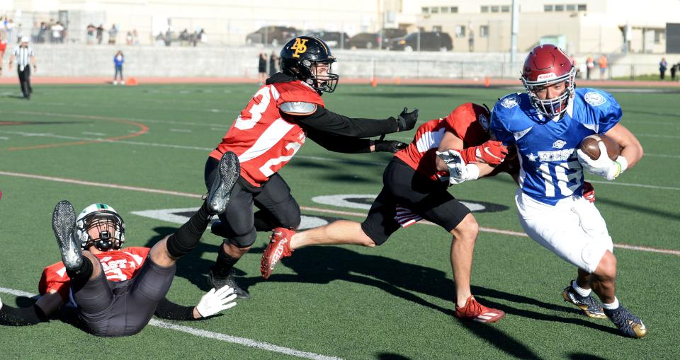 West All-Star Eli Aragon of Oxnard eludes three East All-Star players during the 49th annual Ventura County All-Star Football Game at Ventura College on Saturday, Feb. 4, 2023. The East won, 39-25.