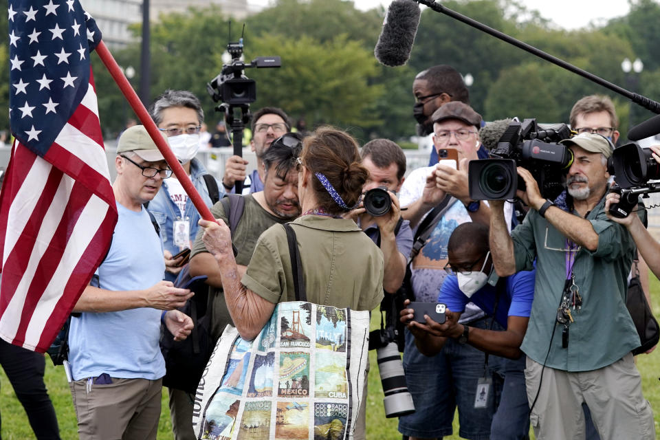 Media gather to listen to a person talking as they attend a rally near the U.S. Capitol in Washington, Saturday, Sept. 18, 2021. The rally was planned by allies of former President Donald Trump and aimed at supporting the so-called "political prisoners" of the Jan. 6 insurrection at the U.S. Capitol. (AP Photo/Alex Brandon)