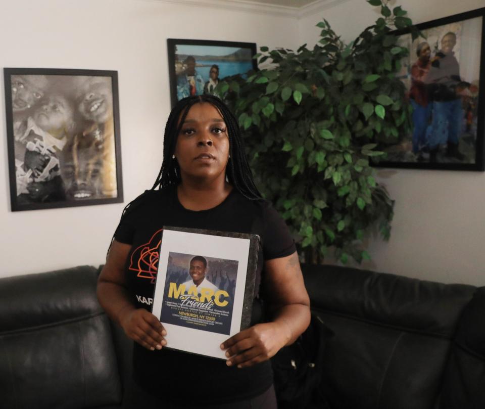 Jemika Hall, holding a flyer for her nonprofit while at her home in Beacon on November 15, 2021. After Hall's son was murdered she decided to start her nonprofit, MARC's Friends in September, 2020 to provide a support group for people in the community who have suffered trauma from violence.   