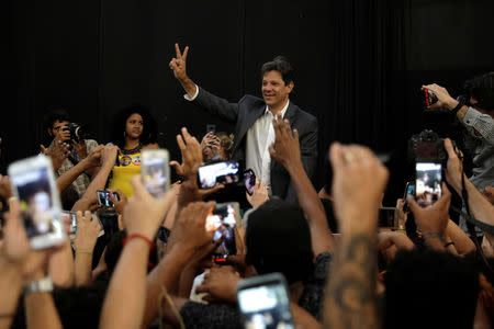 Presidential candidate Fernando Haddad greets supporters during a rally in Mare slums complex in Rio de Janeiro, Brazil October 23, 2018. REUTERS/Ricardo Moraes