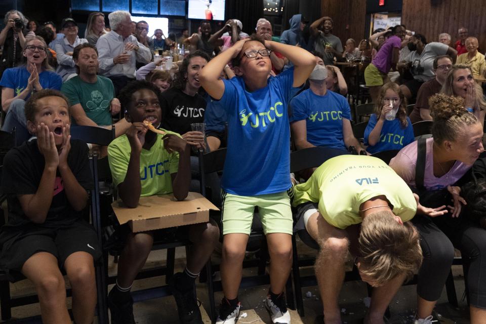Frances Tiafoe's supporters react as they watch the U.S. Open Tennis game between Tiafoe and Carlos Alcaraz during a watch party in College Park, Md., Friday, Sept. 9, 2022. (AP Photo/Jose Luis Magana)