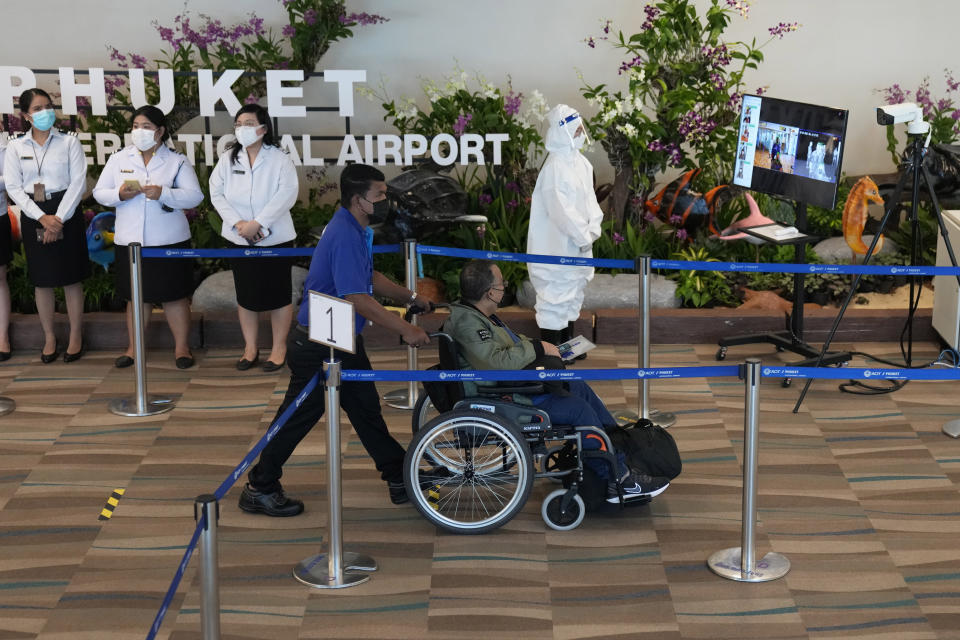 One of the first tourists arrive from Abu Dhabi at the Phuket International Airport in Phuket, Thailand, Thursday, July 1, 2021. Starting Thursday, Thailand will welcome back international visitors — as long as they are vaccinated — to its famous southern resort island of Phuket without having to be cooped up in a hotel room for a 14-day quarantine. (AP Photo/Sakchai Lalit)