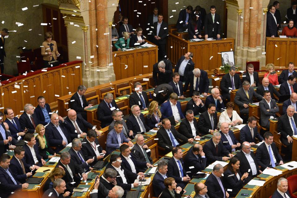 Oppositional lawmakers throw flyers from the balcony at the start of the plenary session of the parliament in Budapest, Hungary, Wednesday, Dec. 12, 2018. (Lajos Soos/MTI via AP)