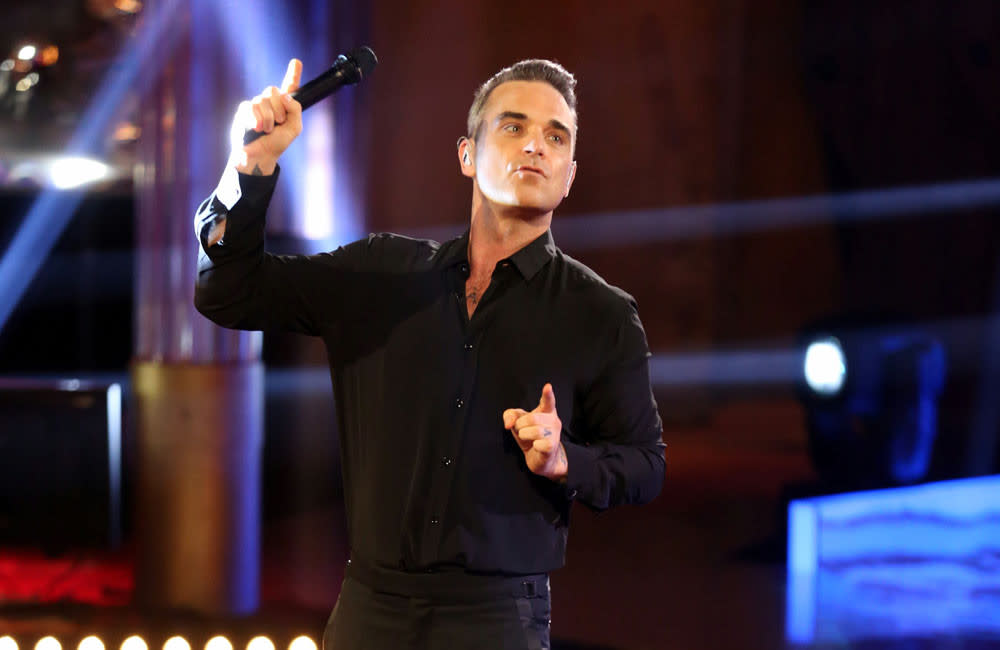 Robbie Williams could perform in a wig credit:Bang Showbiz