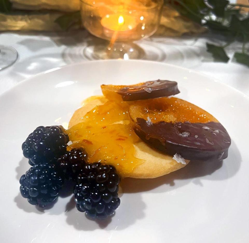 City Farm Feast 2023 dessert: The sweetest thing- a vegan shortbread cookie topped with a candied orange and dark chocolate and blackberries.