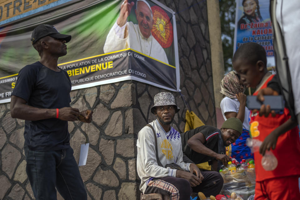 Merchants sell goods outside the Cathedral Notre Dame du Congo in Kinshasa, Democratic Republic of the Congo, Sunday Jan. 29, 2023. Pope Francis will be in Congo and South Sudan for a six-day trip starting Jan, 31, hoping to bring comfort and encouragement to two countries that have been riven by poverty, conflicts and what he calls a "colonialist mentality" that has exploited Africa for centuries. (AP Photo/Jerome Delay)