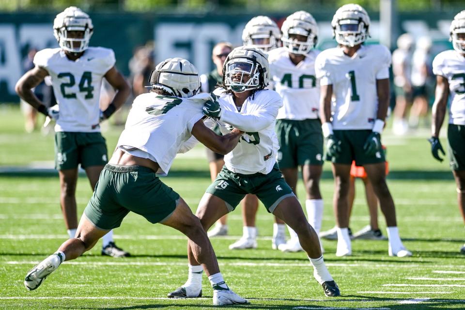 Michigan State safeties Xavier Henderson, left, and Angelo Grose run a drill during football practice on Thursday, Aug. 11, 2022, in East Lansing.