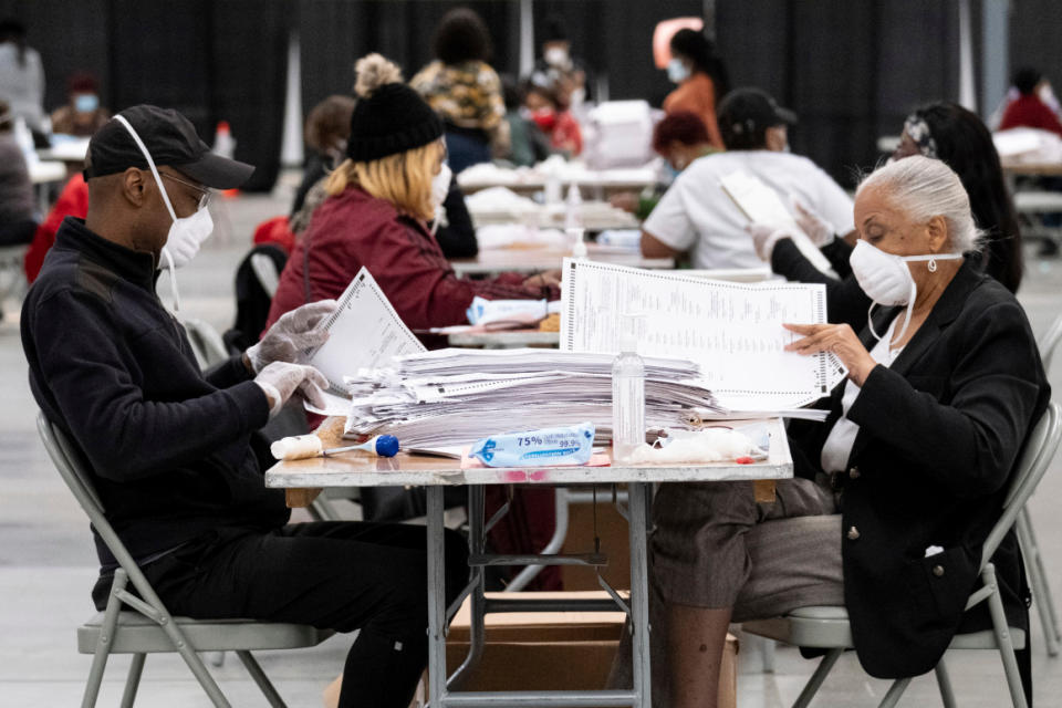 Workers sort and stack ballots in preparation for scanning during a recount in Georgia on Nov. 24. 