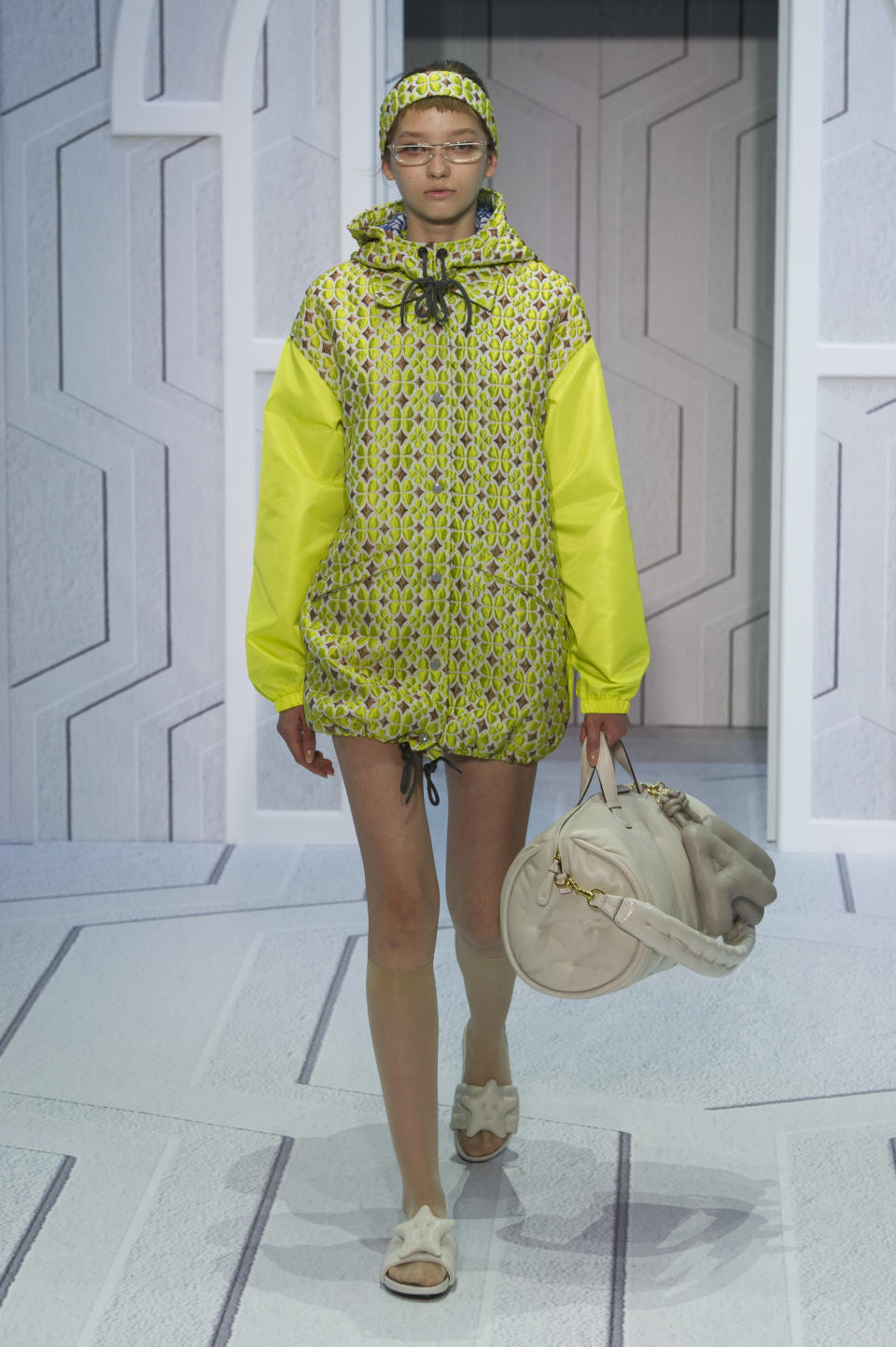 <p><i>Model wears a bright neon green raincoat.(Photo: ImaxTree) </i></p>