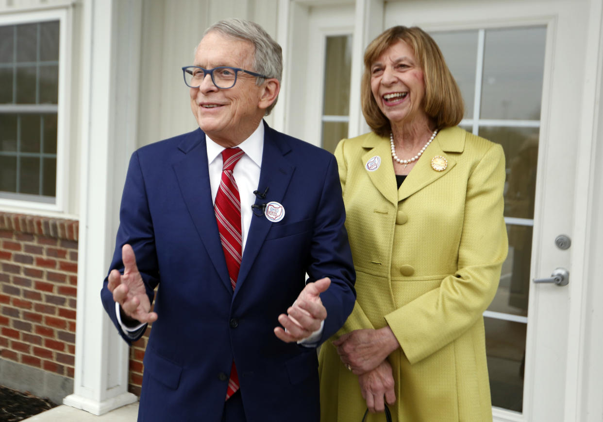 Ohio Gov. Mike DeWine, and his wife, Fran, give an enthusiastic greeting to reporters.