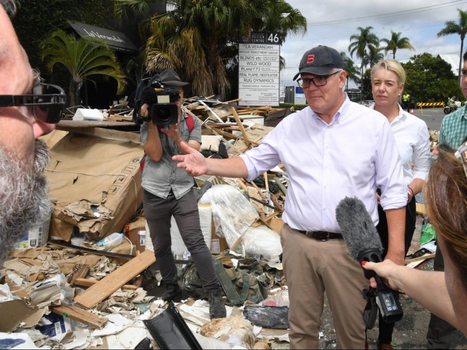 Australian prime minister Scott Morrison inspecting flood damage in the suburb of Brisbane, Queensland,  on 10 March (EPA)