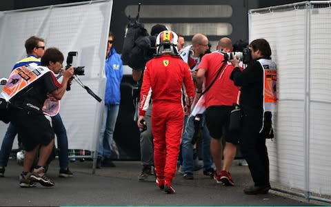 Sebastian Vettel of Germany and Ferrari walks back into the paddock after crashing during the Formula One Grand Prix of Germany at Hockenheimring on July 22, 2018 in Hockenheim, Germany - Credit: getty images