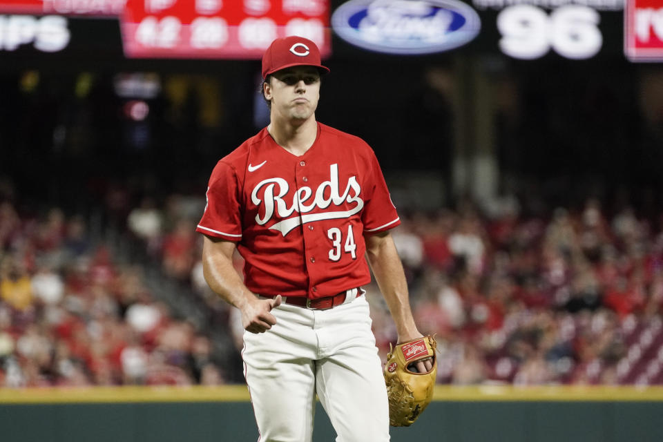 Cincinnati Reds starting pitcher Connor Phillips gives a thumbs-up to the dugout after Pittsburgh Pirates' Jack Suwinski hit a fly ball for an out during the fifth inning of a baseball game Saturday, Sept. 23, 2023, in Cincinnati. (AP Photo/Joshua A. Bickel)