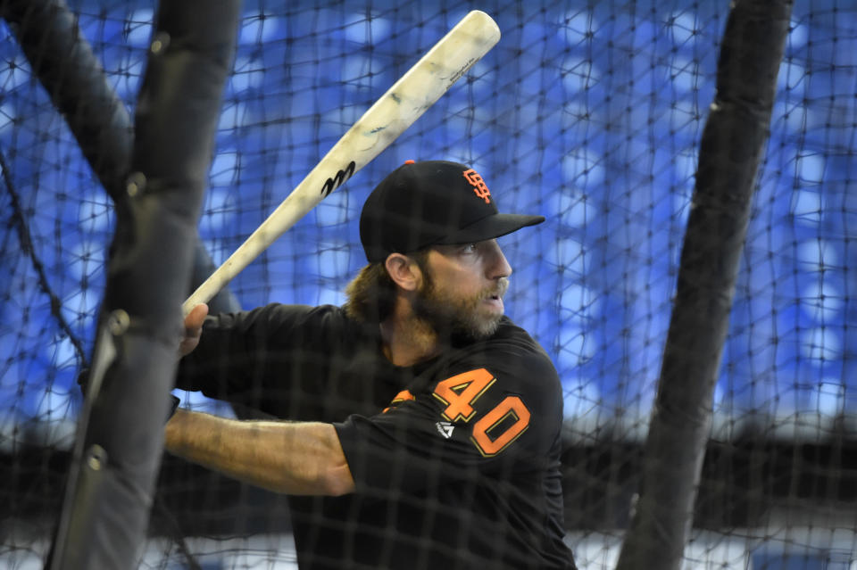 If the universal DH is adopted, we'd lose out on Madison Bumgarner hitting. (Photo by Eric Espada/Getty Images)