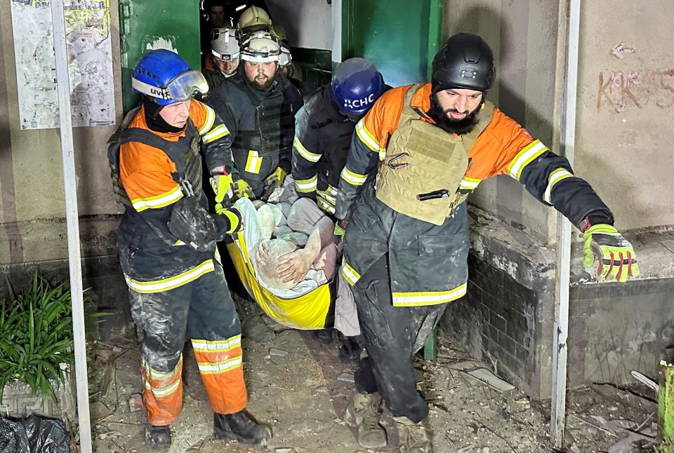 Rescuers evacuate a wounded local resident from a residential building damaged during a Russian drone strike in Kharkiv (REUTERS)