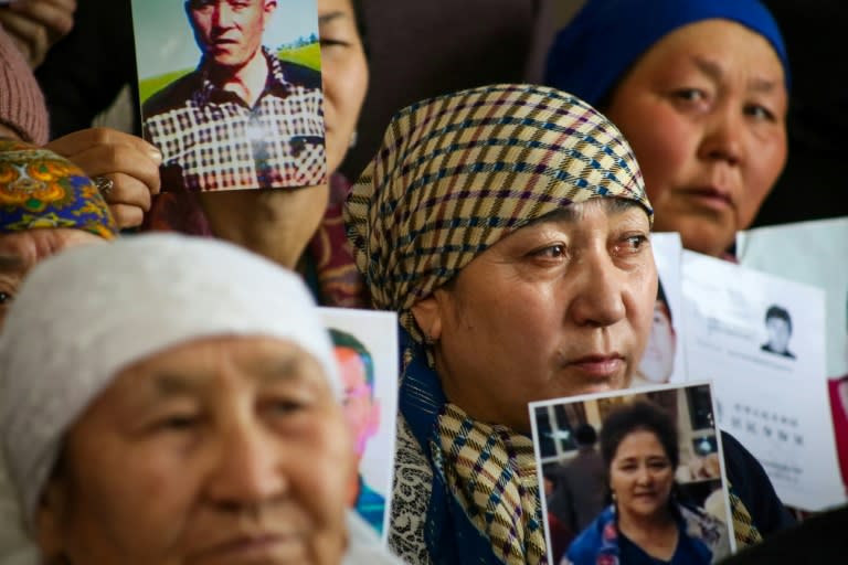 Petitioners with relatives missing or detained in Xinjiang hold up photos of their loved ones during a press event at the office of the Ata Jurt rights group in Almaty, Kazakhstan, on January 21, 2019