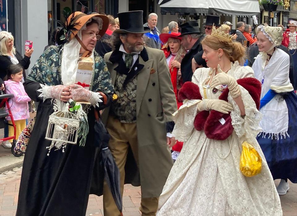 People dressed as Dickensian literary characters take part in parade at the Platinum Jubilee Dickens Festival in Rochester, Kent (PA)