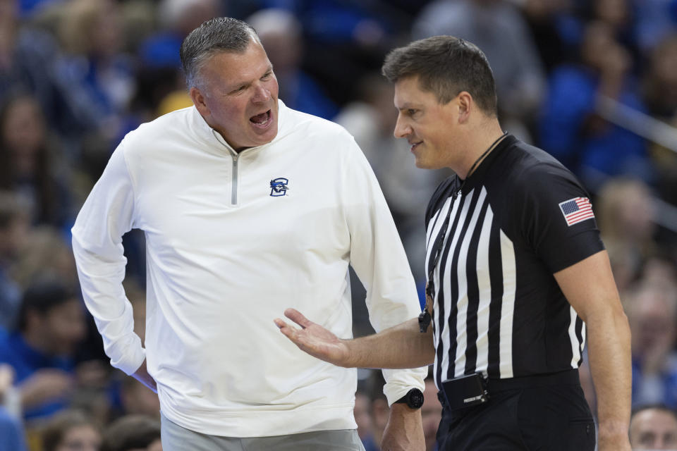 Creighton head coach Greg McDermott, left, argues with a referee about a foul called against his team while playing during the first half of an NCAA college basketball game against Central Michigan, Saturday, Dec. 9, 2023, in Omaha, Neb. (AP Photo/Rebecca S. Gratz)