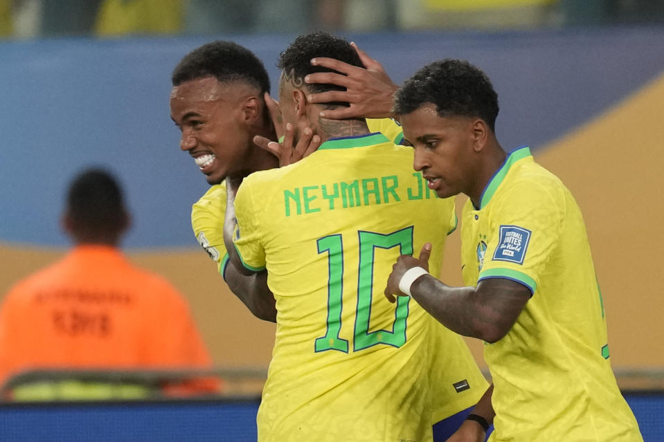 Brazil's Gabriel Magalhaes, left, celebrates with teammates after scoring his side's opening goal against Venezuela during a qualifying soccer match for the FIFA World Cup 2026 at Arena Pantanal stadium in Cuiaba, Brazil, Thursday, Oct.12, 2023. (AP Photo/Andre Penner)