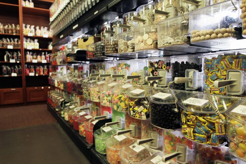 In this photo taken Thursday, July 11, 2013, rows of candy line the wall at the Granite State Candy Shoppe in Concord, N.H. A gaggle of eateries, an independent movie theater, several charming (and killer good) bakeries and a kick-butt independent bookstore has turned Concord into a must-stop for folks headed north for the lakes and mountains. (AP Photo/Jim Cole)