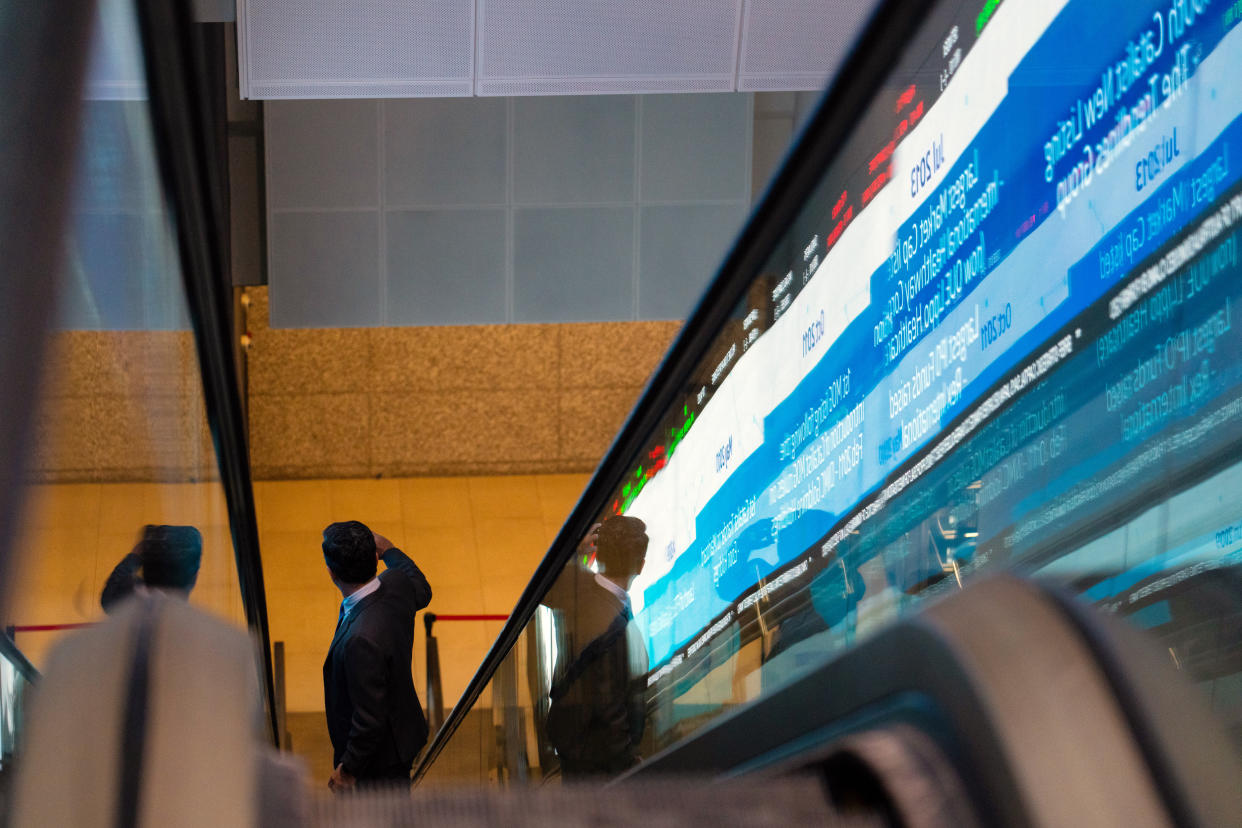 A person riding an escalator is reflected at the Singapore Exchange Ltd. (SGX) headquarters in Singapore, on Tuesday, Feb. 7, 2023. Photographer: Nicky Loh/Bloomberg