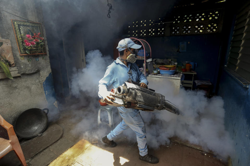 In this photo taken on Sept. 4, 2019, a worker fumigates inside at home in an attempt to control the spread of mosquito-borne diseases in Managua, Nicaragua. As a region, Central America and Mexico have already recorded nearly double the number of dengue cases as in all the previous year. Guatemala, Mexico and Nicaragua have seen double-digit death tolls. (AP Photo/Alfredo Zuniga)