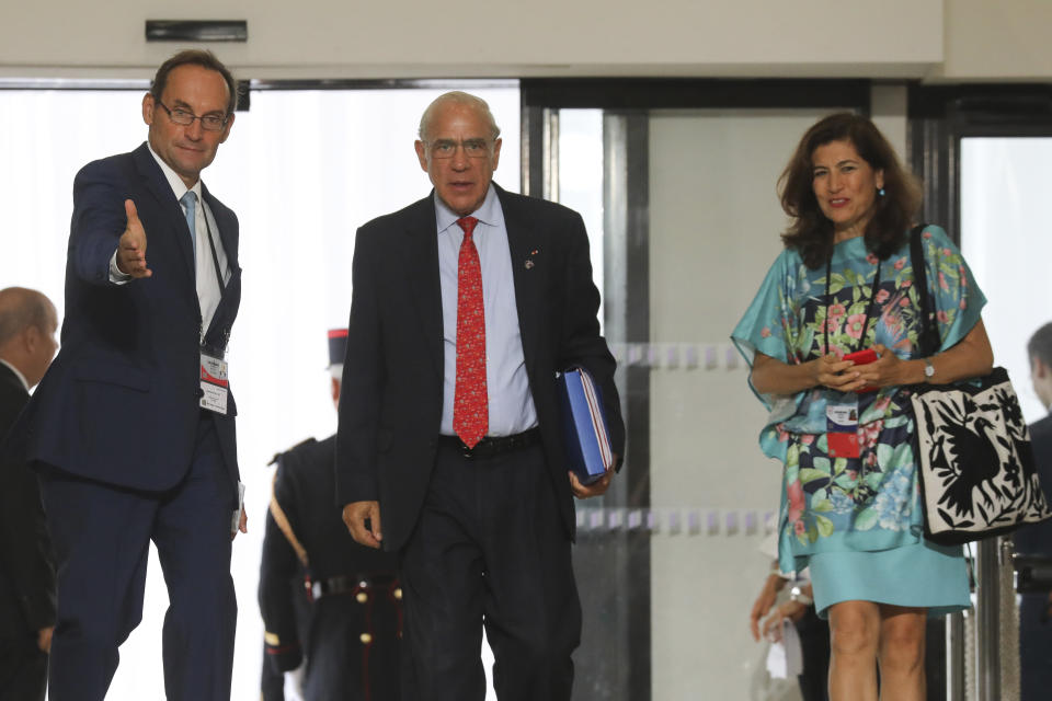 The Organization for Economic Co-operation and Development (OECD) Secretary General Jose Angel Gurria, center, arrives in Biarritz, southwestern France, Sunday Aug. 25, 2019. Fissures emerged among G-7 leaders on Sunday over how to deal with the threat of a global recession, China and Iran, casting deep uncertainty over this year's summit of the world's major democracies as U.S. President Donald Trump appeared increasingly isolated among a gathering of the country's closest allies. (Ludovic Marin/Pool via AP)