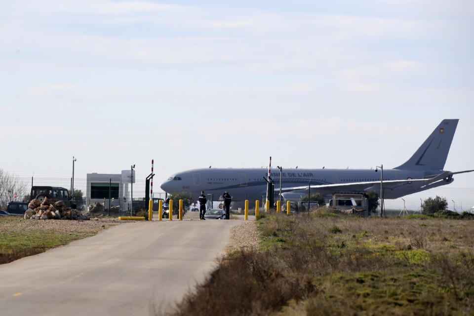 A military plane that carries French citizens from China sits on the tarmac of a military air base, Friday Jan.31, 2020 in Istres, southern France. A planeload of French citizens from the virus-hit Chinese city of Wuhan has landed in southern France, and its passengers are being taken to a Mediterranean vacation resort for 14 days of quarantine.(AP Photo/Daniel Cole)