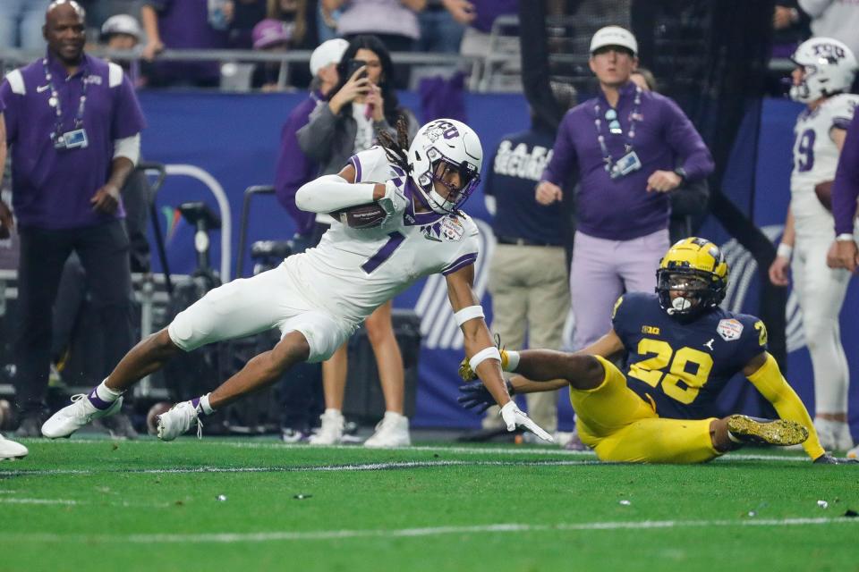 TCU wide receiver Quentin Johnston (1) makes catch against Michigan defensive back Quinten Johnson (28) during the first half at the Fiesta Bowl at State Farm Stadium in Glendale, Ariz. on Saturday, Dec. 31, 2022.