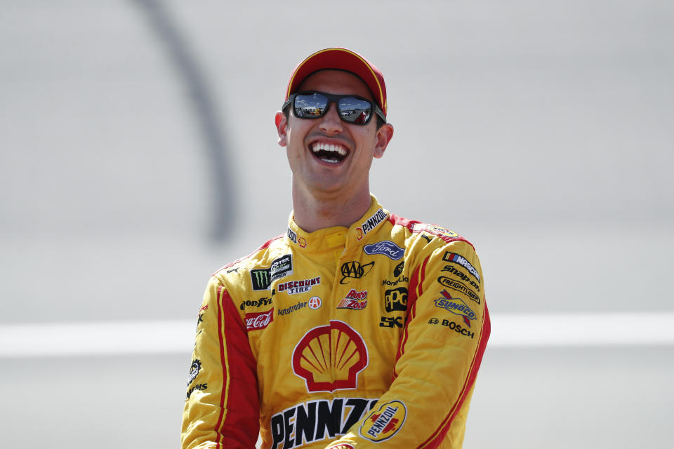 Joey Logano laughs during qualifications for a NASCAR Cup Series auto race at Michigan International Speedway in Brooklyn, Mich., Friday, Aug. 9, 2019. (AP Photo/Paul Sancya)