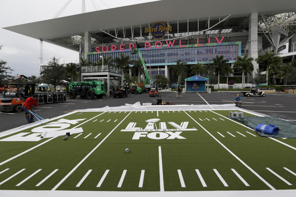 Rudy Morales works on the setup outside of the Hard Rock Stadium Monday, Jan. 27, 2020, in Miami Gardens, Fla., in preparation for the NFL Super Bowl 54 football game. (AP Photo/Chris Carlson)