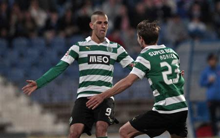 Sporting's Adrien Silva (23) celebrates his goal against Belenenses with teammate Islam Slimani during their Portuguese Premier League soccer match at Restelo stadium in Lisbon April 19, 2014. REUTERS/Hugo Correia