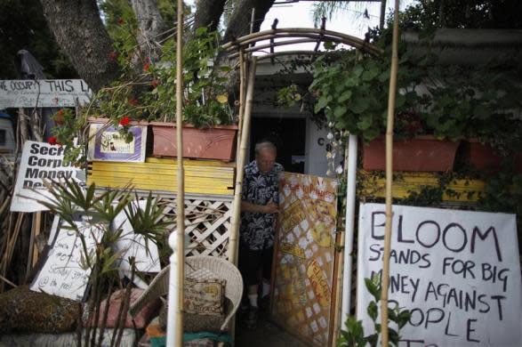 Peter Norton, 63, walks out of his trailer covered in protest signs in Village Trailer Park in Santa Monica, July 13, 2012.