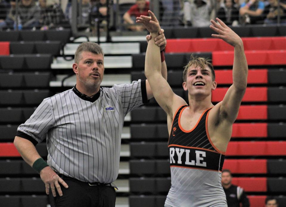 Ryle senior Cole Thomas reacts and holds up four fingers on his left hand after winning his fourth career state championship at the KHSAA state wrestling championships, Feb. 26, 2022, at George Rogers Clark High School, Winchester, Ky.