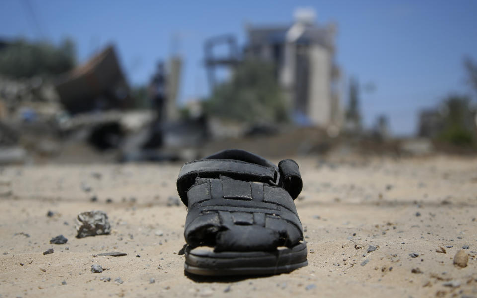 CORRECTS DATE TO MONDAY, MAY 17, 2021, NOT TUESDAY, DEC. 3, 2019 - A sandal lies on the ground after a house was hit by early morning Israeli airstrikes in Beit Lahyia, northern Gaza Strip, on Monday, May 17, 2021. The Israeli military unleashed a wave of heavy airstrikes Monday on the Gaza Strip, saying it destroyed 15 kilometers (9 miles) of militant tunnels and the homes of nine Hamas commanders as international diplomats worked to end the weeklong war that has killed hundreds of people. (AP Photo/Hatem Moussa)