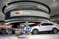 Workers construct the display area for Cadillac before the start of Press Days for the North American International Auto Show at Cobo Center in Detroit, Michigan, U.S., January 12, 2018. REUTERS/Rebecca Cook