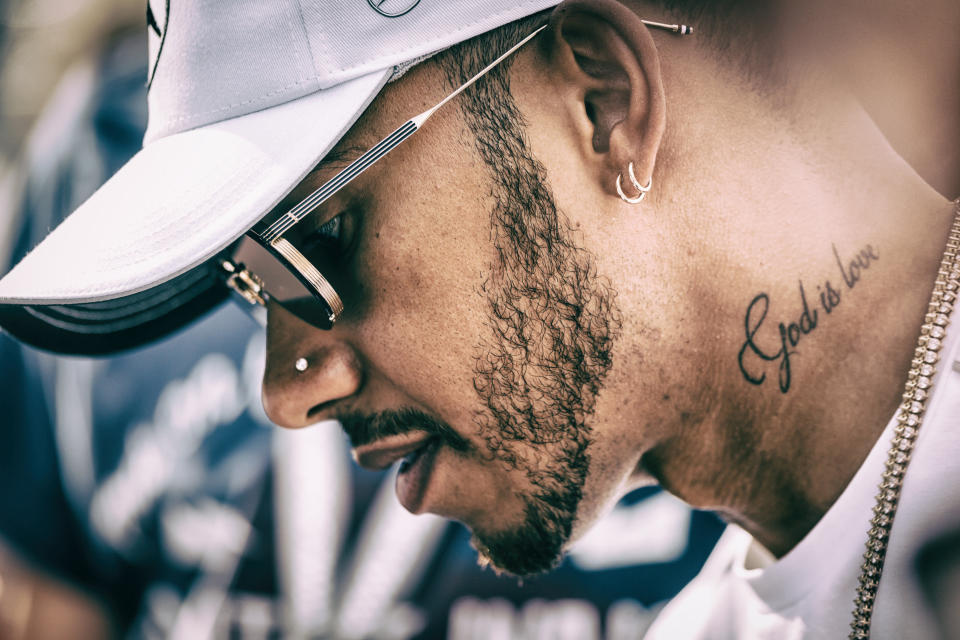 Getting it in the neck: Lewis Hamilton and one of his many tattoos, each of which says something about the man himself