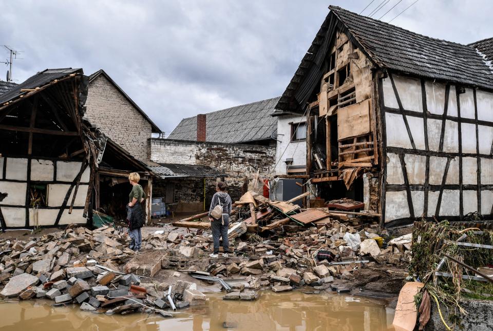 Local residents inspect the damage in Schuld (EPA)