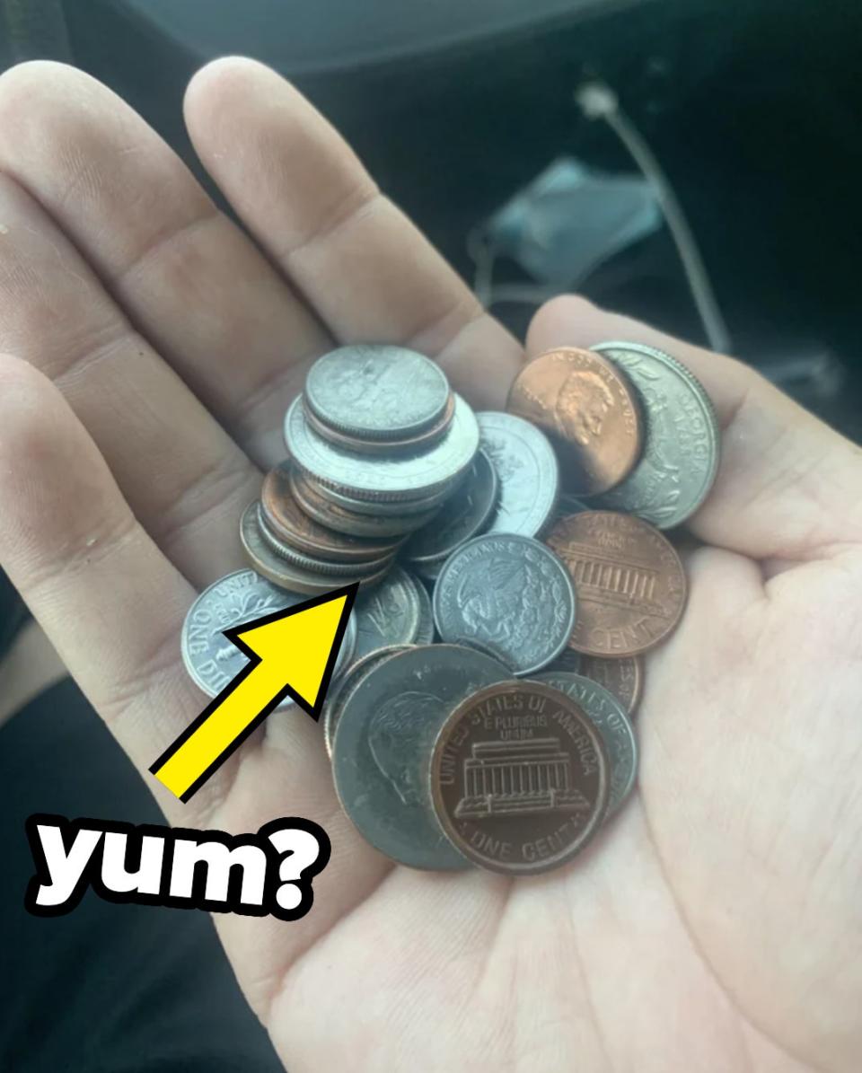 A person is holding a handful of change