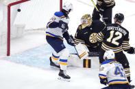 Boston Bruins goaltender Jeremy Swayman (1) looks back at the puck on a goal by St. Louis Blues right wing Kasperi Kapanen (42) during the first period of an NHL hockey game, Monday, March 11, 2024, in Boston. (AP Photo/Charles Krupa)