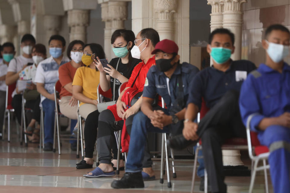 A number of traders are lining up to get the Covid-19 vaccine at Tanah Abang Market, Central Jakarta City. Source: Getty