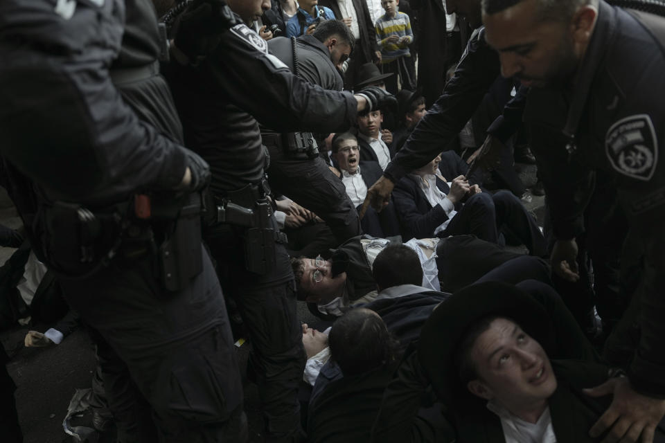 Israeli police officers disperse Ultra-Orthodox Jews blocking a highway during a protest against army recruitment in Bnei Brak, Israel, Thursday, June 27, 2024. Israel's Supreme Court unanimously ordered the government to begin drafting ultra-Orthodox Jewish men into the army — a landmark ruling seeking to end a system that has allowed them to avoid enlistment into compulsory military service. (AP Photo/Oded Balilty)